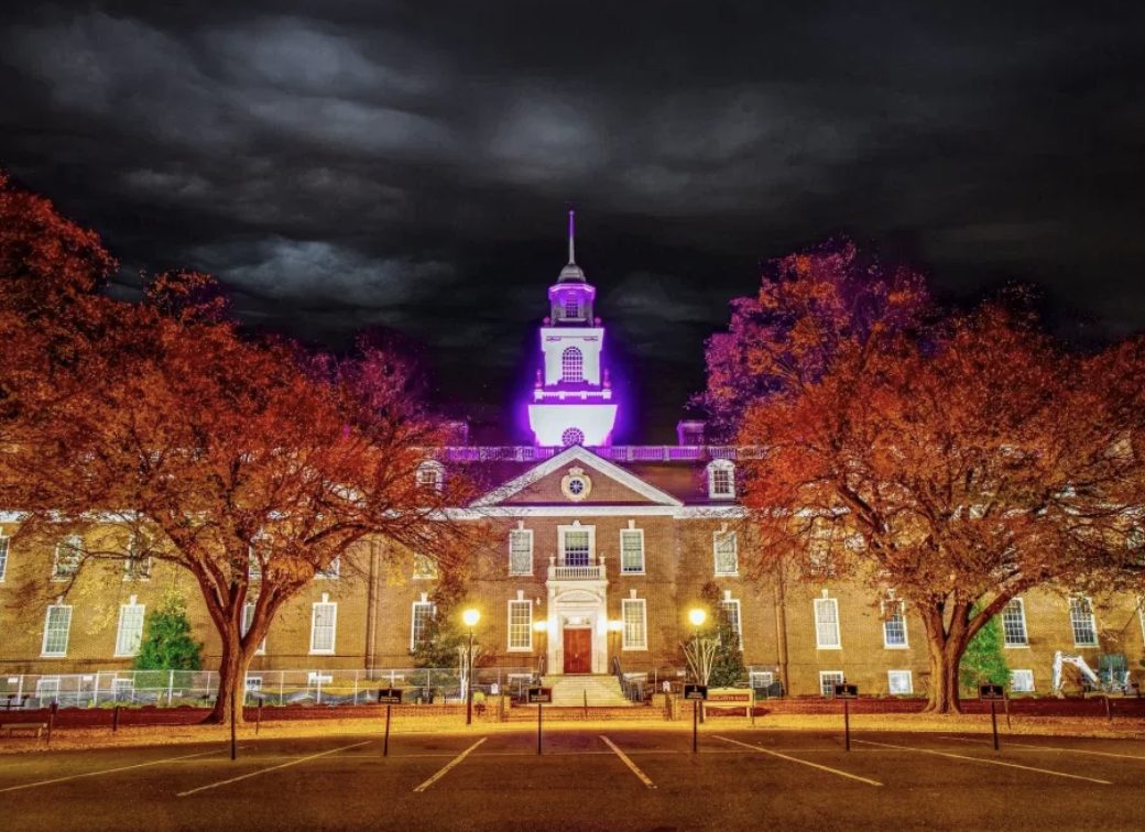 Legislative Hall in Dover, Delaware, lit up at night with fall trees, near the Halloween Trunk or Treat Bash